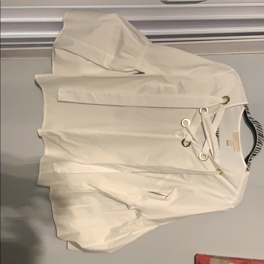 White top with gold accents and flows sleeves